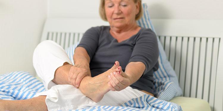 Old Women having problems of sensitivity to touch or cold in her foot.